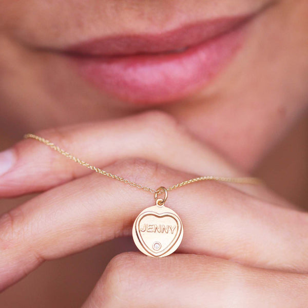 Love Hearts 18ct Gold Name Charm worn on a gold chain around a models neck