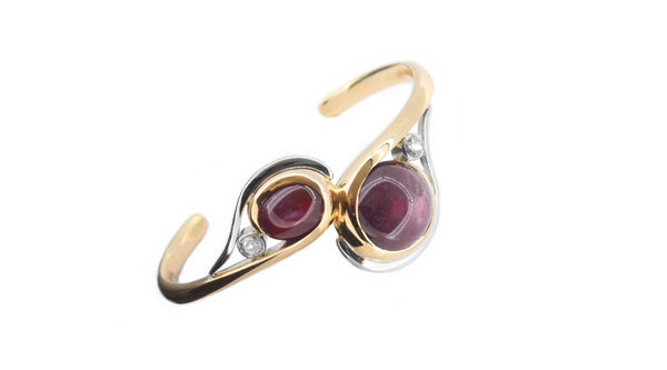 Bespoke jewellery design of a ruby bangle in a swirling design hand made in white and yellow gold with diamonds