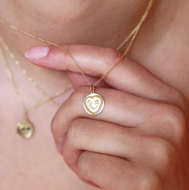 Love Hearts Wink Gold Charm worn on a model