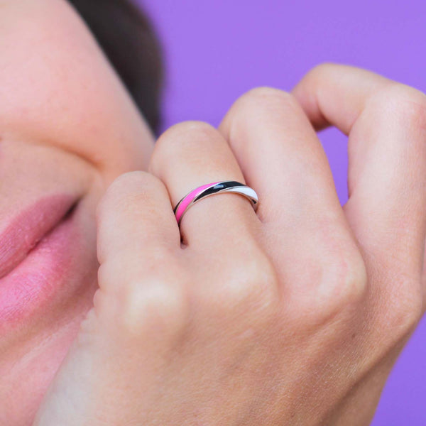 Rock candy allsorts ring in platinum with black, white and neon pink enamel. worn on a model